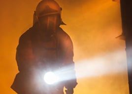 Firefighter carries a handlamp into the Ex-Zone.